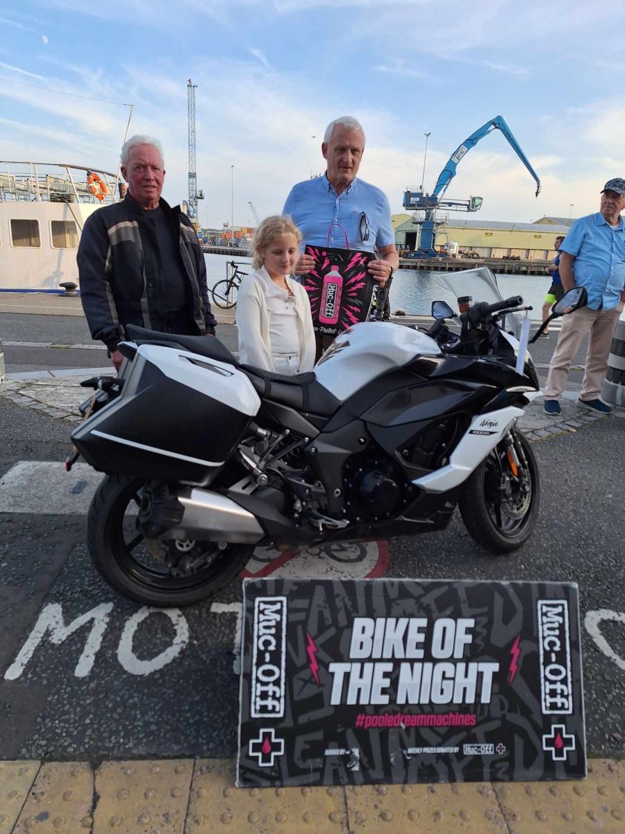 Bike night winner with his motorbike and the judge 